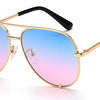 Stylish aviator sunglasses with gold frame and blue-to-pink gradient lenses, UV protection