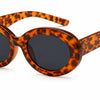 Tortoiseshell oval sunglasses with dark lenses, stylish women's UV-protected fashion shades