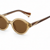 Oval sunglasses with translucent gold acetate frames and brown lenses, featuring tortoiseshell-patterned temples.