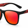 Stylish women's sunglasses with black frames, red-orange mirrored lenses, and patterned arms for UV protection and polarization.