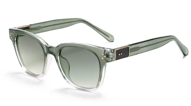Oversized square sunglasses with a translucent smoky green acetate frame and gradient gray-green lenses, featuring gold-tone metal rivets and a dark brown rectangular accent on the temple.