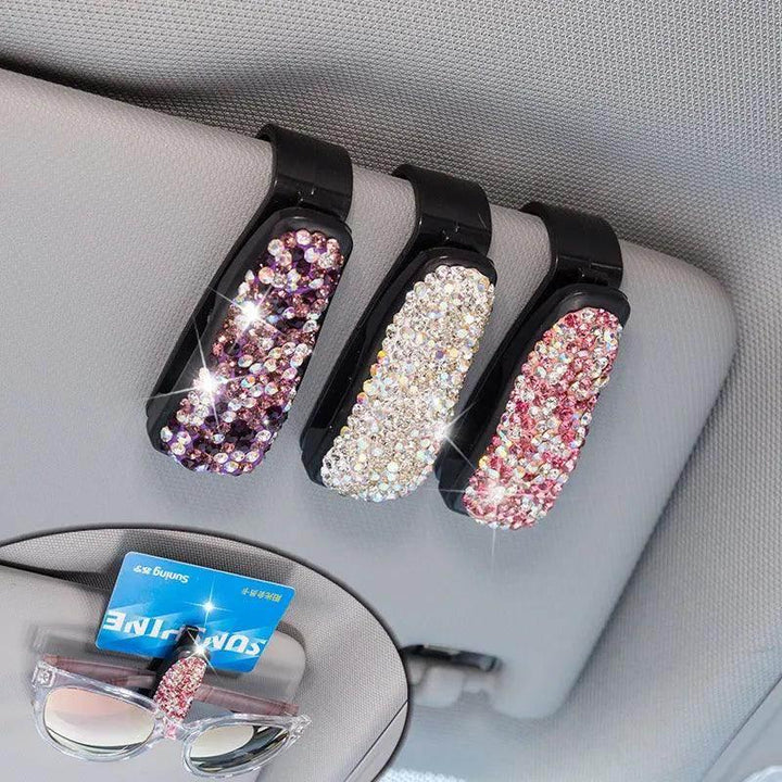 Sparkly rhinestone car visor clips holding sunglasses and cards, stylish auto accessory for women