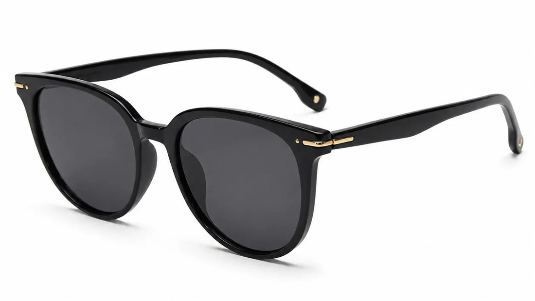 Black round sunglasses by Fox Shades with a glossy black frame, dark smoke lenses, slim black arms, and gold hinge accents.