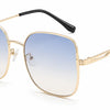 Gold frame women's sunglasses with blue to clear gradient lenses, UV protection, stylish design