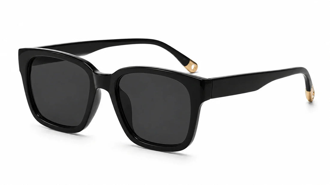 Black square sunglasses by Fox Shades with a glossy black frame, dark smoke lenses, wide arms, and gold-toned temple tips
